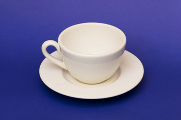 White cup isolated on the blue background