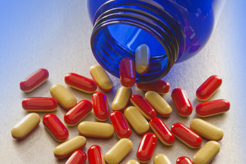 Red and yellow capsules on blue
