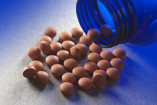Brown pills on blue