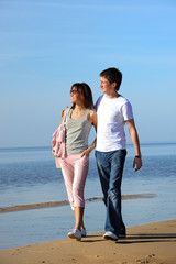 Young couple walking on the beach