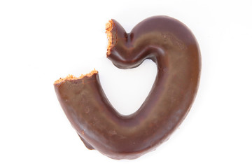 Chocolate covered gingerbread heart partially bitten