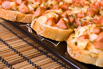Baked small snacks on black plate