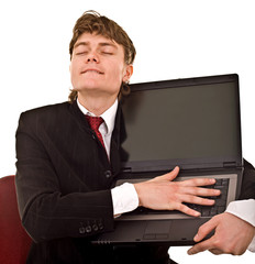 Businessman with laptop in office.