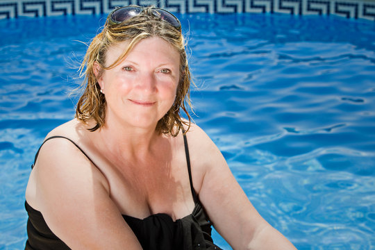 Shot of a Senior Lady Sitting by the Pool