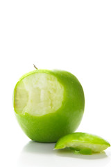 green apple on white, with a bite taken out