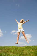 Fototapeta na wymiar Happy young woman jumping