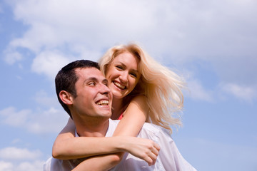 Young love Couple smiling under blue sky