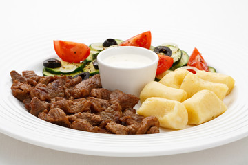 Grilled meat, dumplings and vegetable salad