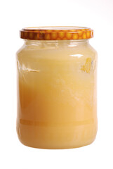 A jar of honey isolated on white background