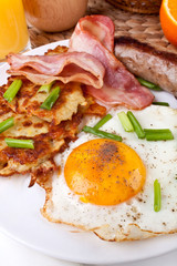 classic breakfast meal - bacon, egg, sausage and hash browns