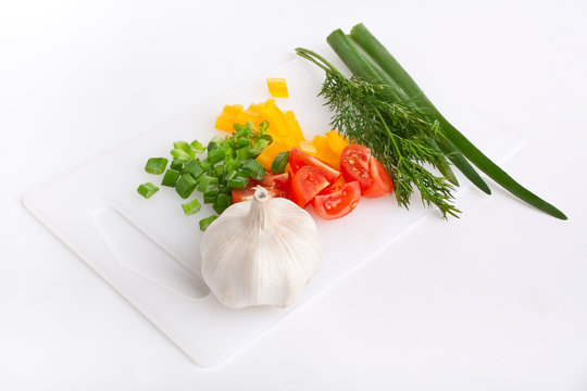 Vegetables on a plastic chopping board
