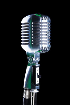Retro microphone on stand isolated on black background