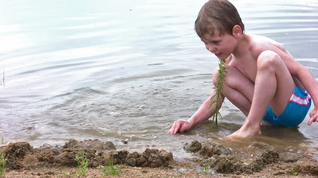 boy play sand on beach