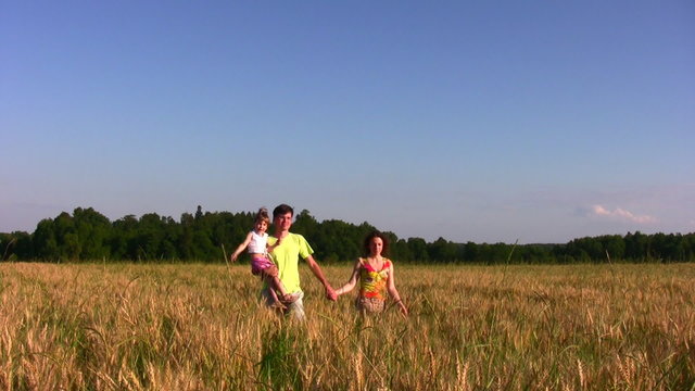 family with little girl in field