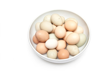 Bowl of free range eggs isolated on a white studio background.