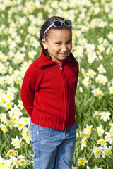 Little Girl Playing In Daffodils