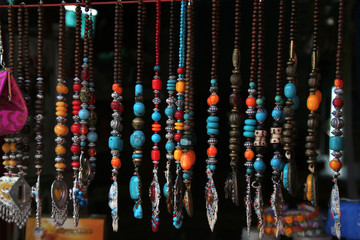 Display of chains of colourful beads and pendants