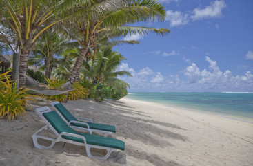 Obraz na płótnie Canvas Tropical Beach with Palm Trees and Lounge Chairs