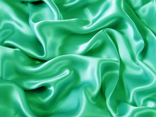 Smooth elegant green silk fabric as background