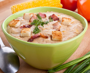 one serving of corn cream soup puree on wooden table
