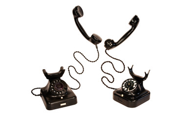 Two black vintage telephones, isolation on white