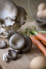Fresh oyster mushrooms on a chopping block