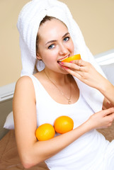 pretty girl eating oranges
