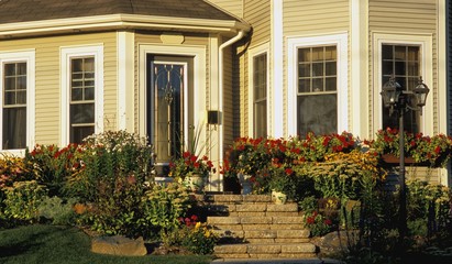 The front entrance of a house with a flower garden