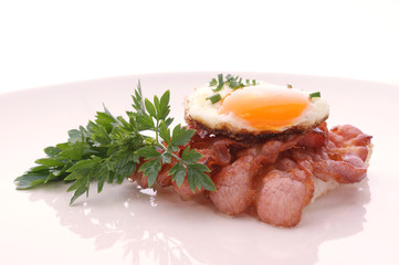 Spiegelei mit gebratenen Speckstreifen auf Toast