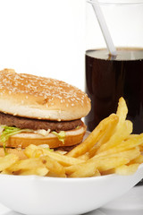 Hamburger meal served with french fries and soda close-up