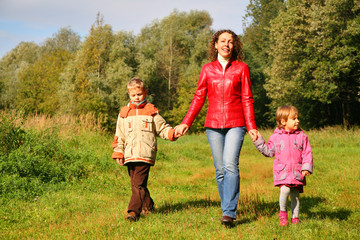 Obraz premium Mother with children on walk in wood, front view