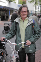 Fototapeta na wymiar Old man with his city bike
