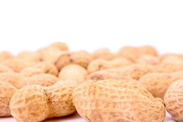 Many peanuts on white background