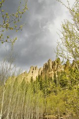 Dutch Creek hoodoos and spring foliage with cloudy sky..