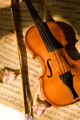 Naklejka premium Old violin, fiddle-stick and music sheet