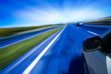 Obraz na płótnie Canvas motion blurred road and car