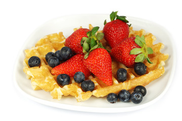 Plate of waffles with berries isolated