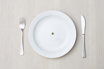 A single pea on a plate