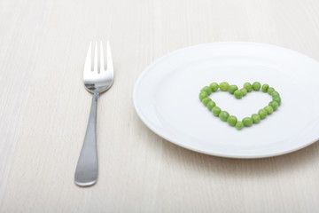 Peas creating a heart shape on a plate