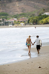 couple on beach san juan del sur nicaragua pacific ocean