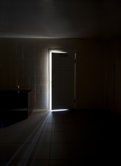 Inside a dark room with half-opened doors
