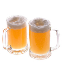 Two mugs of beer covered of water drops