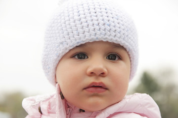Beautiful baby girl with white hat