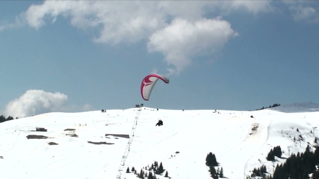Para glider lands at snowy ski resort