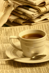 Cup  coffee on a morning paper business news