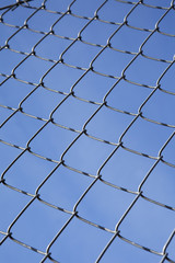 Fototapeta premium Fence as a pattern towards blue sky