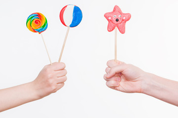 Hands with lollipops