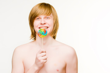 Cheerful red-haired man with lollipop