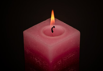red square candle in dark
