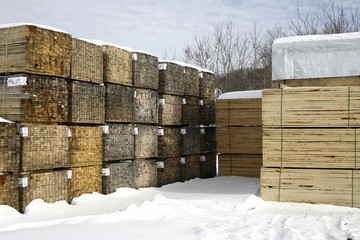 Piles of softwood lumber in winter